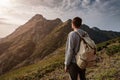 Young man standing on top of cliff mountains Royalty Free Stock Photo