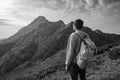 Young man standing on top of cliff mountains Royalty Free Stock Photo