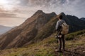 Young man standing on top of cliff mountains Royalty Free Stock Photo