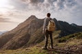 Young man standing on top of cliff mountains Royalty Free Stock Photo