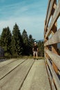 Young man standing on top of wood crossover, Sumava National Park, Czech republic and Germany