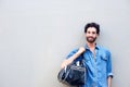 Young man standing with travel bag over shoulder Royalty Free Stock Photo