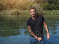 Young man standing in water in sea or lake Royalty Free Stock Photo