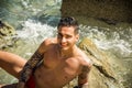 Young man standing in water by sea or ocean shore, Royalty Free Stock Photo