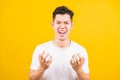 Young man standing wearing white t-shirt he expressions irate, angry face