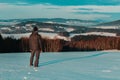 Young man standing in winter czech landscape looking to valley Royalty Free Stock Photo