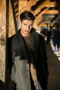 Young man standing on wooden footbridge in Switzerland while looking away