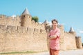 A young man stands at the fortress wall of the medieval city of Carcassonne in France Royalty Free Stock Photo