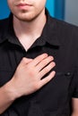 A young man stands and makes himself a lymphatic massage with his hand in the chest area, close-up Royalty Free Stock Photo