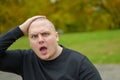 Young man staring at camera with aghast expression