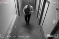 Footage Of Man Stealing Computer Monitor Walking In Corridor Royalty Free Stock Photo