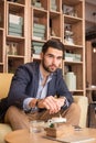 Young man stirring coffee cup indoors caffee bar Royalty Free Stock Photo