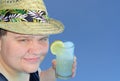 Young Man in a Straw Fedora Holding a Glass of Lemonade Royalty Free Stock Photo
