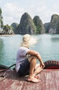 Young man in a straw hat enjoying the boat ride at Lan Ha Bay, Cat Ba island, Vietnam Royalty Free Stock Photo