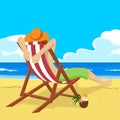 Young man in straw hat sitting in deck chair on tropical beach looks into the distance Royalty Free Stock Photo