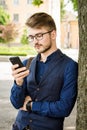 Young man in the street with a phone in his hands Royalty Free Stock Photo