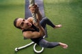 Young man strength training by climbing a rope