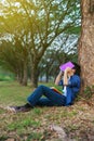 Young man in stress situation when reading a book in park