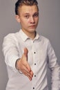 A young man stretches out his hand, showing his greetings. Royalty Free Stock Photo