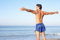 Young man stretching on beach Royalty Free Stock Photo