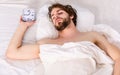 Young man stretching while waking up in the morning. Cheerful young man is waking up after sleeping in the morning Royalty Free Stock Photo
