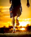 Young man strong legs off trail running at amazing summer sunset in sport and healthy lifestyle Royalty Free Stock Photo