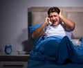 Young man struggling from noise in bed Royalty Free Stock Photo