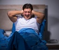 Young man struggling from noise in bed Royalty Free Stock Photo