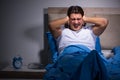 The young man struggling from noise in bed Royalty Free Stock Photo