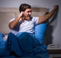 Young man struggling from noise in bed Royalty Free Stock Photo