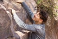 Young man struggling while rock climbing Royalty Free Stock Photo