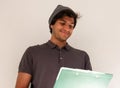 Young man student smiling standing looking at a folder over white background Royalty Free Stock Photo