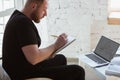 Young man studying at home during online courses for programmer, bug-tester, consulter