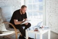 Young man studying at home during online courses for programmer, bug-tester, consulter