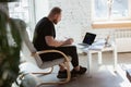 Young man studying at home during online courses for programmer, bug-tester, consulter