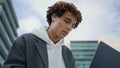 Young man studying laptop outdoors portrait. Focused student learning at street Royalty Free Stock Photo