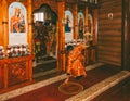 The young man subdeacon straightens the rug in front of the altar in an Orthodox Church at the divine Liturgy Royalty Free Stock Photo