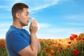 Young man suffering from allergy and blooming field Royalty Free Stock Photo