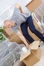 Young man suffering from backpain while lifting carton Royalty Free Stock Photo