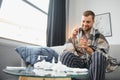 Young man suffering from cold at his home. Shot of a young man sitting on his bed while feeling unwell at home. Trying Royalty Free Stock Photo