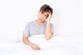 Young man suffering from headaches after wake up on the bed. Healthcare medical or daily life concept Royalty Free Stock Photo