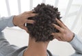 Young man suffering from itchy scalp