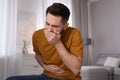 Young man suffering from nausea at home Royalty Free Stock Photo