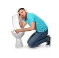 Young man suffering from nausea near toilet bowl Royalty Free Stock Photo