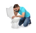 Young man suffering from nausea near toilet bowl Royalty Free Stock Photo