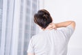 Young man suffering neck and shoulder pain from uncomfortable bed. Healthcare medical or daily life concept Royalty Free Stock Photo