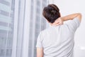 Young man suffering neck and shoulder pain from uncomfortable bed. Healthcare medical or daily life concept Royalty Free Stock Photo
