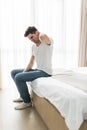 Young man suffering from neckache in bed Royalty Free Stock Photo