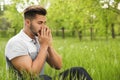 Young man suffering from seasonal allergy outdoors on sunny day Royalty Free Stock Photo