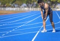 young man suffering from sudden knee and leg pain during the workout at the stadium Royalty Free Stock Photo